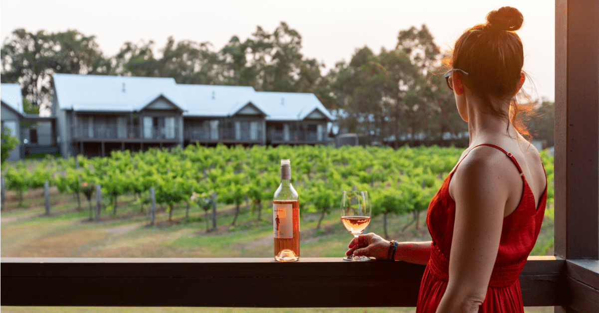 Woman drinking wine overlooking the vineyards in Hunter Valley